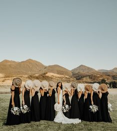 a group of women standing next to each other on top of a lush green field