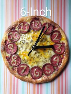 a close up of a pizza on a table with the time six o'clock