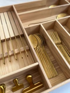 an open wooden box filled with golden utensils