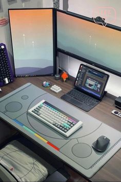 a desk with two computer monitors and a laptop on it, along with a keyboard