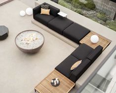 an outdoor living area with couches and tables