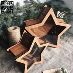 three wooden boxes sitting next to each other on top of a carpeted floor in front of a christmas tree