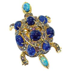 Bochic "Orient” Opal & Blue Sapphire Turtle Brooch Set In 18K Gold & Silver From the "Orient” collection Natural Opals - 5.5 carats Natural shapes Natural Blue Sapphires - 15 carats Cabochons shapes Natural Fancy color sapphires, round brilliant - 4.5 carat Sri Lankan Sapphire colors - Red, Pink, Rose, Yellow, White Opals colors - Ocean blue, turquoise, Green, Navy blue Set in 18K Gold and Silver The Brooch is one of a kind the perfect cross between -Day to night, swim wear to evening wear. Mult Antique Gold Brooches With Cabochon, Luxury Turquoise Brooch Jewelry, Luxury Turquoise Brooches, Luxury Exquisite Gemstone Brooches, Turtle Brooch, Figural Jewelry, Sapphire Color, Opal Color, Natural Blue Sapphire