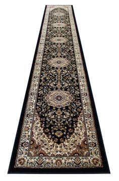 a black and beige rug with an intricate design on the bottom, in front of a white background