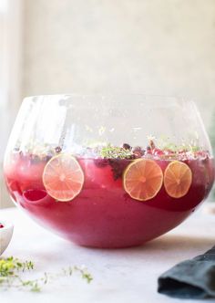 a bowl filled with liquid and orange slices