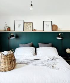 a bed with white sheets and pillows in a room