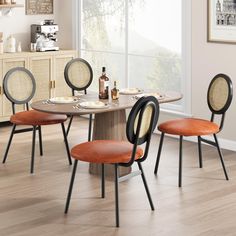 a dining room table with four chairs around it