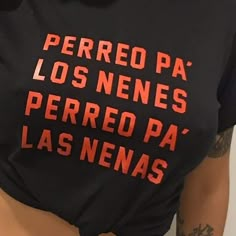 a woman wearing a black shirt with red writing on it's chest and the words perreo pa los nenes perreo pa las nevadas