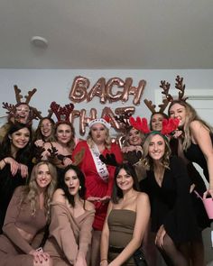 a group of women posing for a photo in front of a sign that says bach christmas