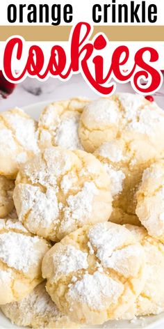 orange crinkle cookies on a white plate with powdered sugar in the middle