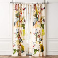 the curtains are hanging on the wall in front of the window with flowers and leaves painted on them