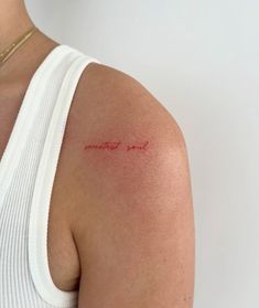 a woman with a red tattoo on her arm