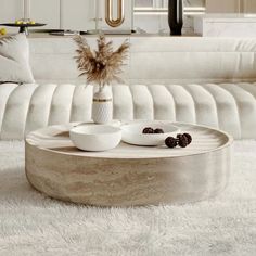 a living room filled with white furniture and pillows