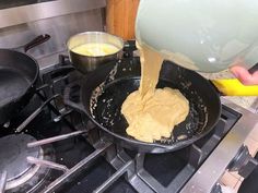 someone is pouring batter into a pan on the stove