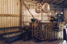 an old wooden cart with balloons in the shape of numbers on it and some other decorations