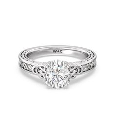 a white gold engagement ring with an intricate design