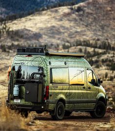 a van is parked on the side of a dirt road