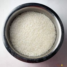 a bowl filled with white rice on top of a table