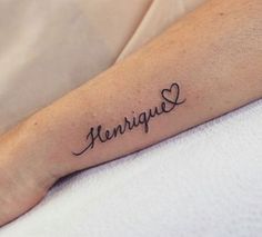 a person with a tattoo on their arm that says hennus