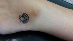 a small tattoo on the foot of a person