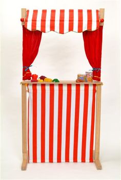 an orange and white striped tent with red curtains