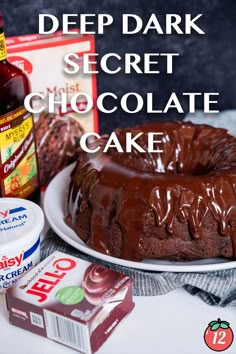 a chocolate cake sitting on top of a white plate next to a bottle of ketchup