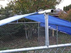 a blue tarp on top of a metal fence