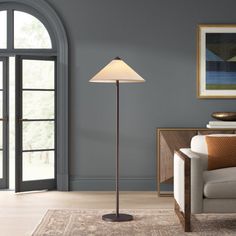 a living room scene with focus on the floor lamp