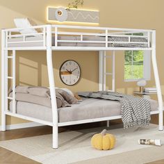 a white bunk bed with a clock on the wall above it and a rug in front of it