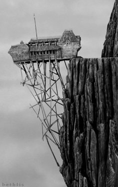 an upside down view of a building on top of a rock formation in the sky