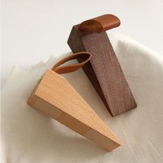 two pieces of wood sitting on top of a white cloth