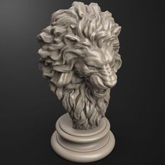 a statue of a lion head on a pedestal