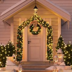 a house decorated with christmas lights and wreaths