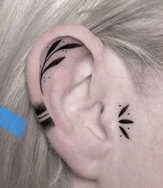 a woman's ear with black lines on it