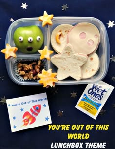 a lunch box with food in it and an image of a frog on the side