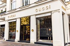 a gucci store front on a city street in the middle of europe stock photo