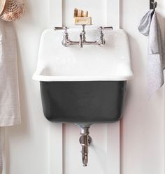 a black and white sink hanging on the wall