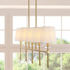 At just over three-feet long, this linear pendant is perfectly sized to hang over a kitchen island or dining room table. The simple, elegant frame features lucite accents; the five warm LED bulbs are softened by ivory linen shades. This versatile linear pendant is ideal for modern, minimalist dining rooms as well as traditional spaces. JONATHAN Y Sophie 38.5" Iron Mid-Century 5-Light Brass Gold Modern/Contemporary Linear LED Large Hanging Kitchen Island Light | JYL9919A Dining Room Round Lighting Over Table, Rectangle Chandelier Over Kitchen Island, Island Linear Lighting, Dining Room Light Fixtures Over Table, Hallway Paneling, Linear Chandelier Dining Room, Dining Lights, Floor Office, Transitional Dining