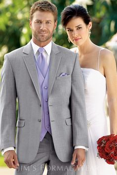 a man and woman in wedding attire posing for the camera with an advertise