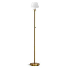 a gold floor lamp with a white shade on the top and a black light bulb at the bottom