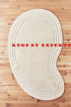 rugs by experts on wooden floor with red lettering