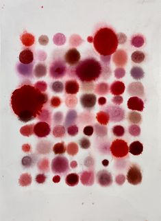 an abstract painting with red and pink circles on white paper in the center is a square shape