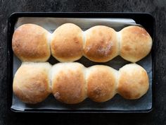 several rolls in a baking pan on a table