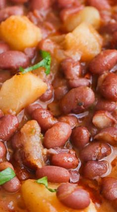 beans and pineapples are cooked together in a skillet, ready to be eaten