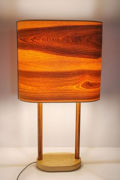 a lamp made out of wood with a wooden base