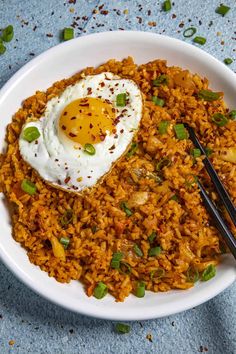 a white bowl filled with rice and fried egg