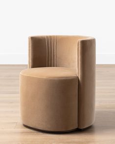 a beige chair sitting on top of a hard wood floor