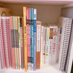 a book shelf filled with lots of books on top of each other in different languages