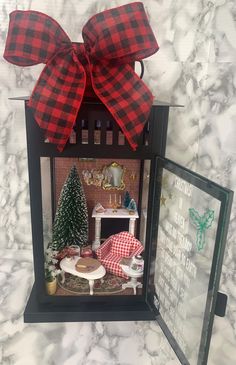 a doll house with a red and black bow