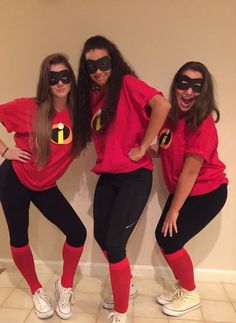 three women dressed up as the incredibles posing in front of a wall with their hands on their hips